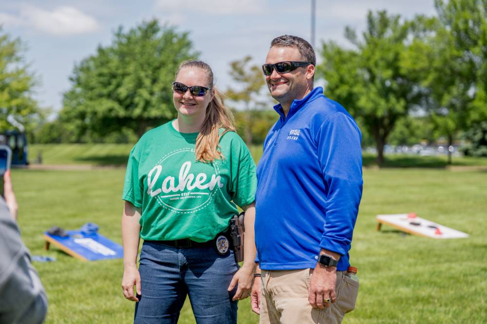 Two players smile together wearing GV gear and sunglasses